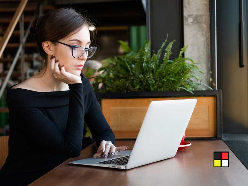 A homeowner researching energy-efficient windows online, with a laptop open to a government website listing incentives